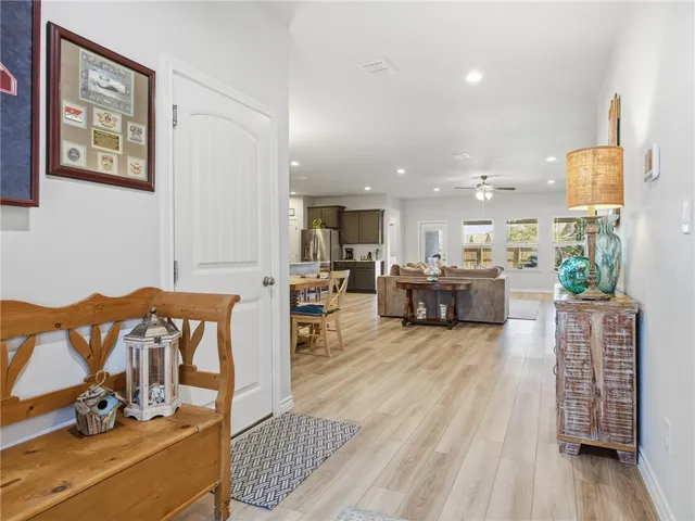 a living room with furniture a wooden floor and a large window