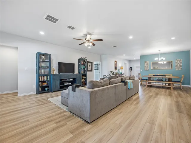 a living room with furniture and a wooden floor