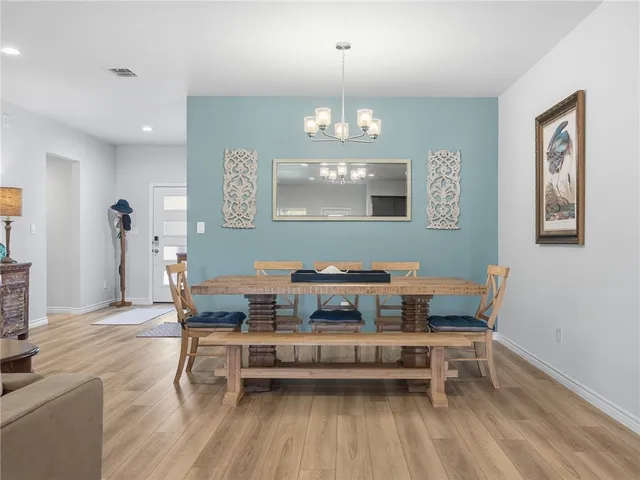 a living room with furniture a window and wooden floor