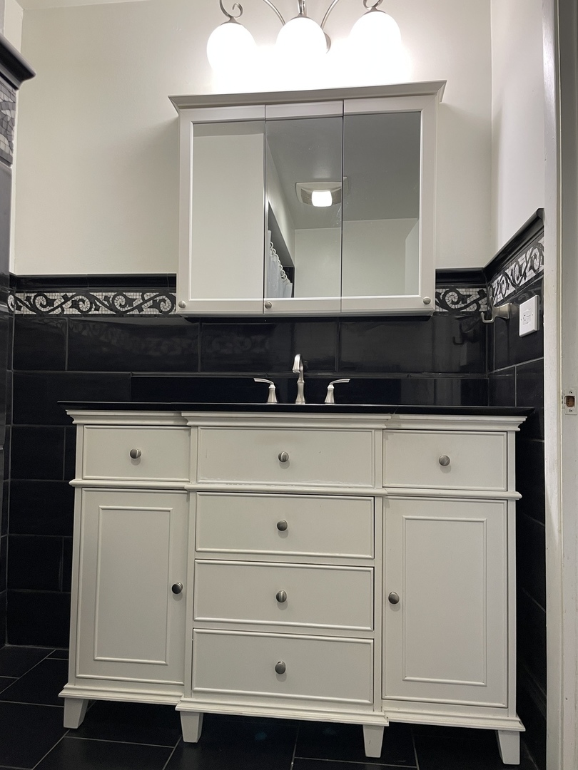 9137 Barberry Lane, Unit 9137 Des Plaines, IL 60016 - Photo 16 of 22 a bathroom with a sink and a mirror
