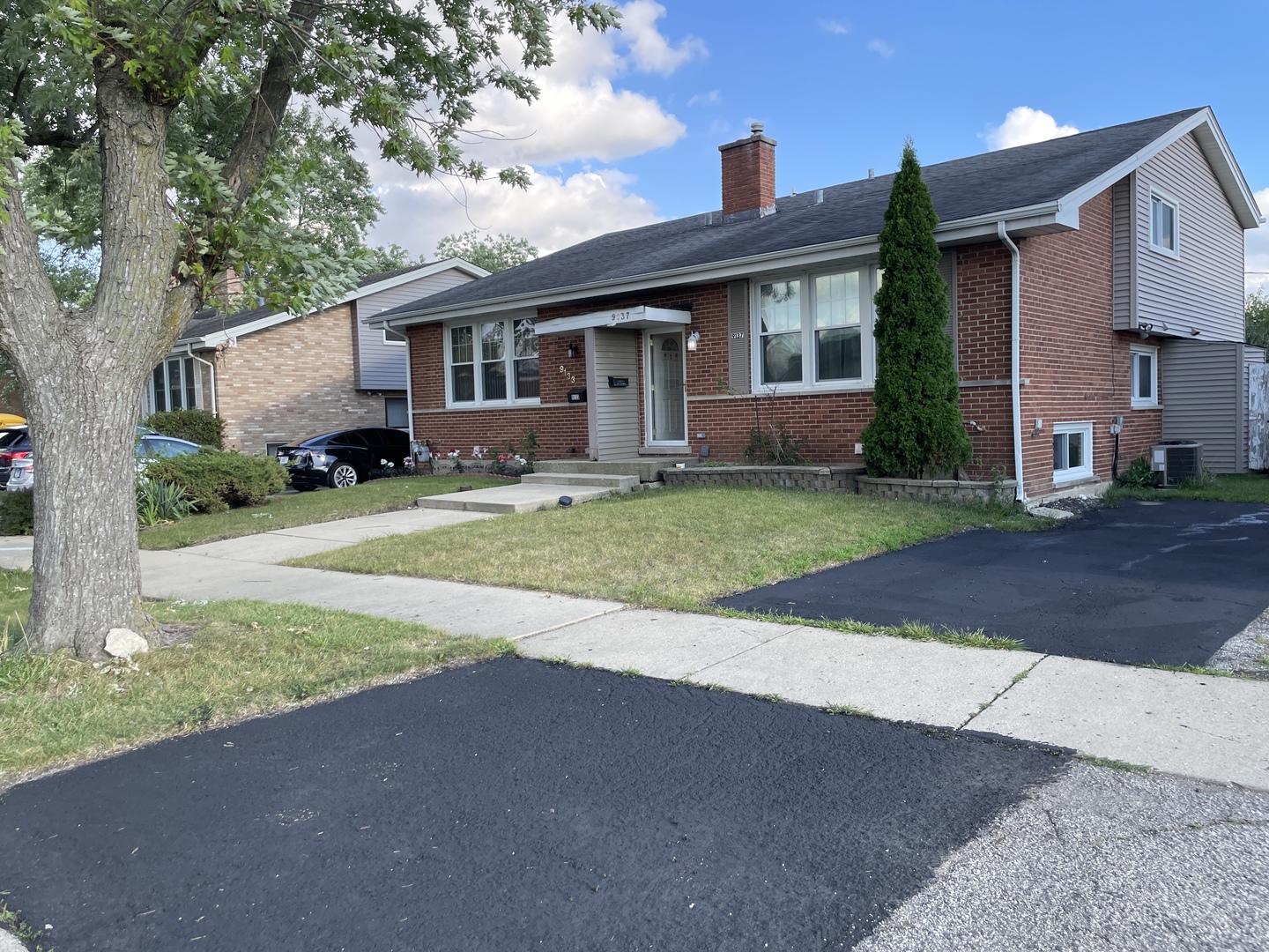 9137 Barberry Lane, Unit 9137 Des Plaines, IL 60016 - Photo 2 of 22 a front view of a house with a yard and garage