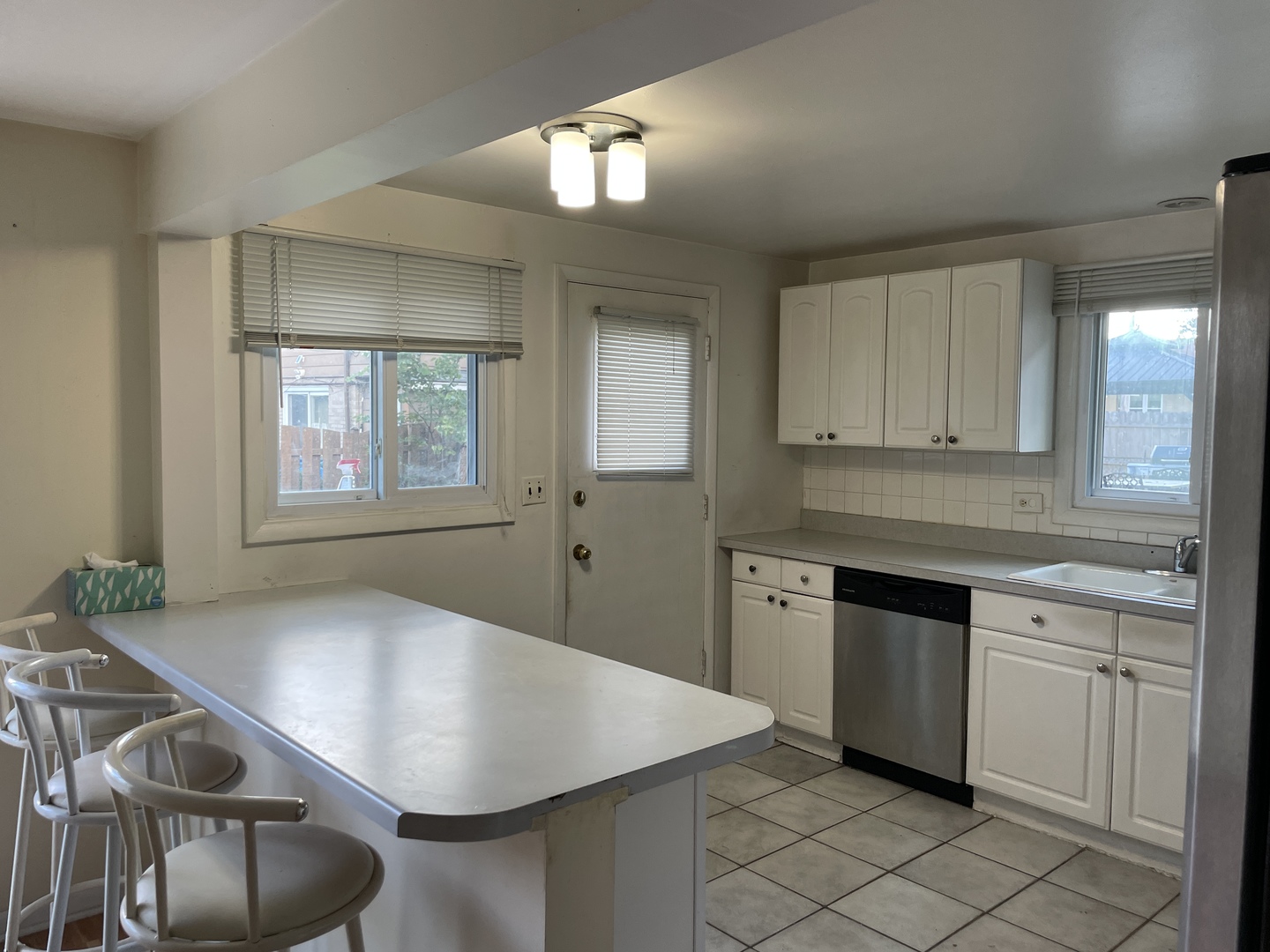 9137 Barberry Lane, Unit 9137 Des Plaines, IL 60016 - Photo 9 of 22 a kitchen with stainless steel appliances granite countertop a stove a sink and a refrigerator