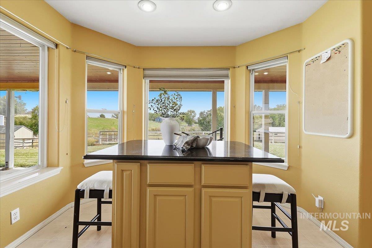7900 Labor Camp Road Caldwell, ID 83607 - Photo 13 of 45 Built-in island with dark countertop, multiple windows, and recessed lighting