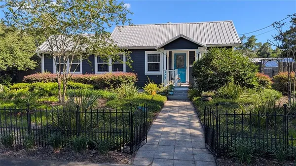 a front view of a house with a garden