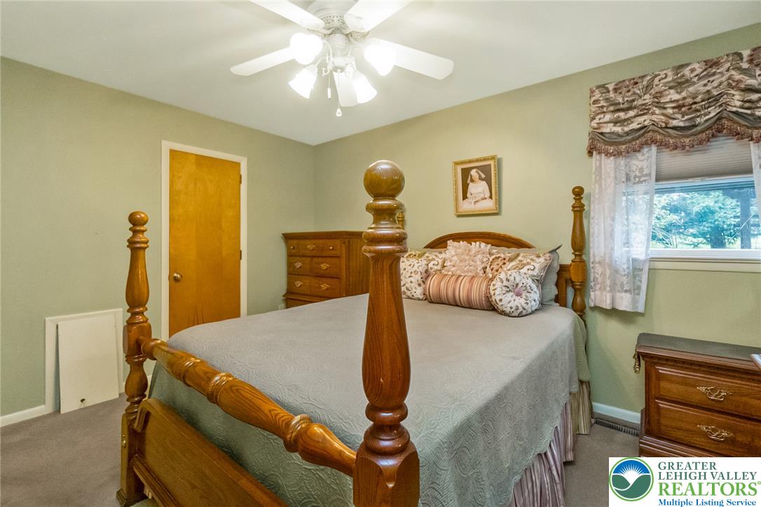 1328 Russett Road Allentown, PA 18104 - Photo 29 of 46 A comforting bedroom features carpeted floors and a prominent ceiling fan, enhancing air circulation and light.