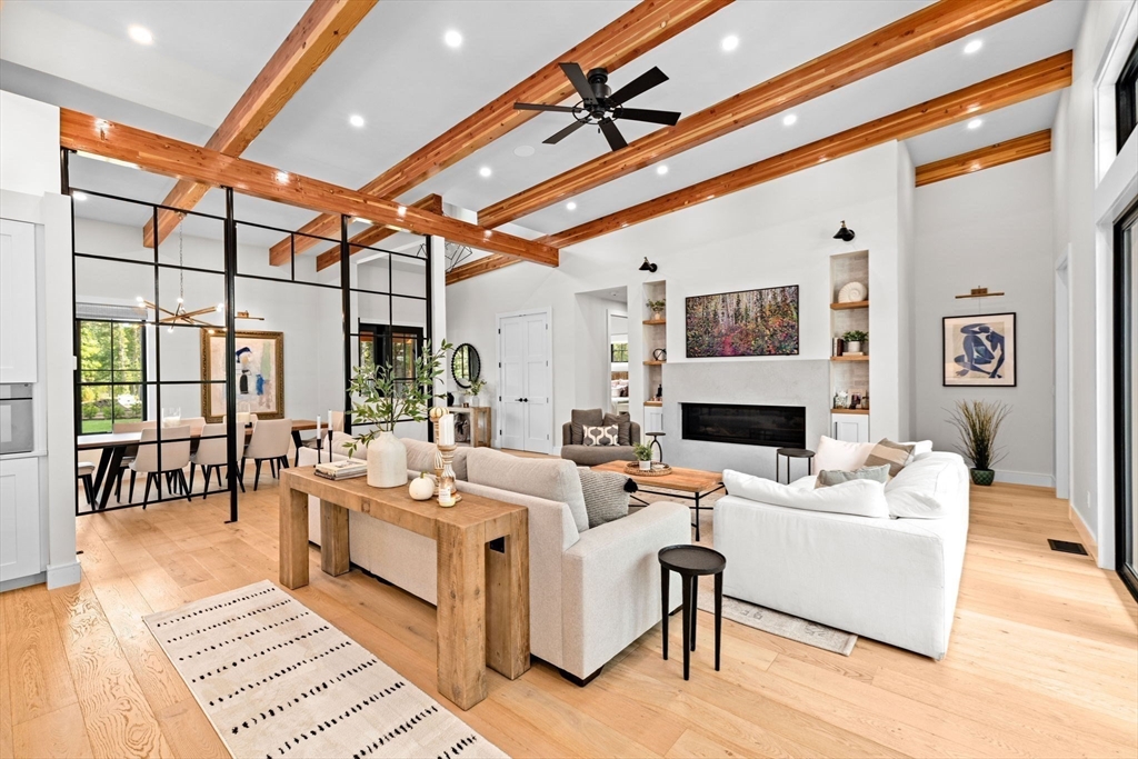 a living room with furniture a fireplace and a table