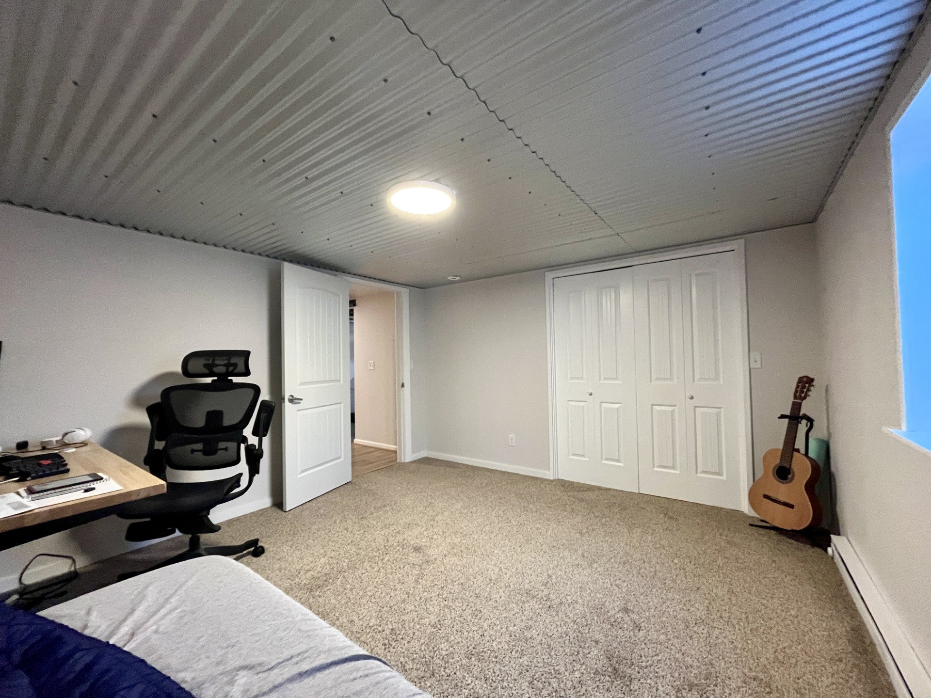 1344 Beaverhead Road Helena, MT 59602 - Photo 41 of 45 Bedroom featuring a baseboard radiator, an office area, a closet, and light carpet