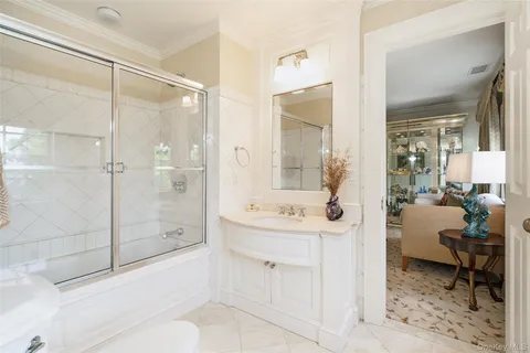 a spacious bathroom with a shower sink and mirror