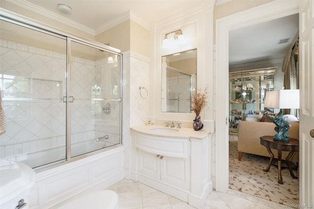 a spacious bathroom with a shower sink and mirror