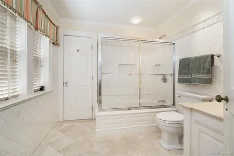 a bathroom with a toilet a sink and shower