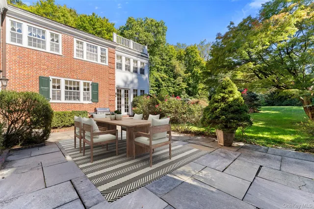 a view of a patio with table and chairs and potted plants