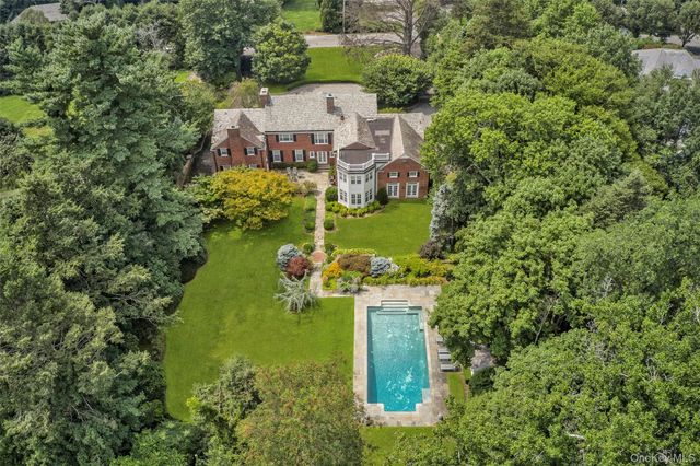 an aerial view of a house with a yard and lake view