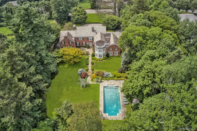 an aerial view of a house with a yard and lake view
