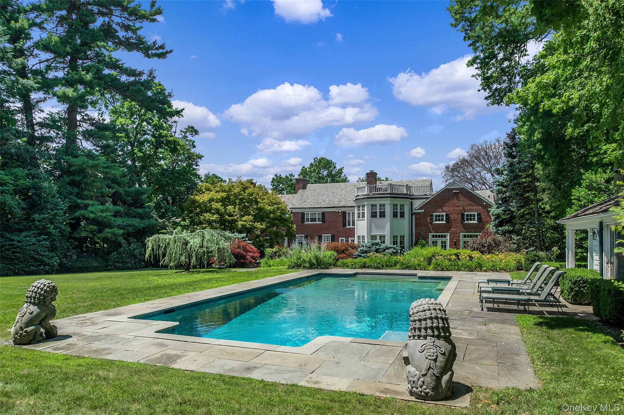 8 Cooper Road Scarsdale, NY 10583 - Photo 31 of 38 a view of a garden with a bench in the garden