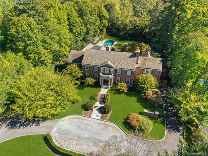 an aerial view of a house with a yard basket ball court and outdoor seating