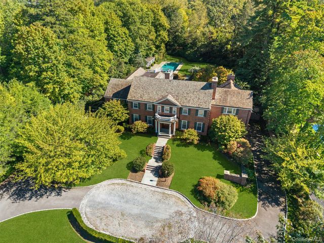 an aerial view of a house with a yard basket ball court and outdoor seating