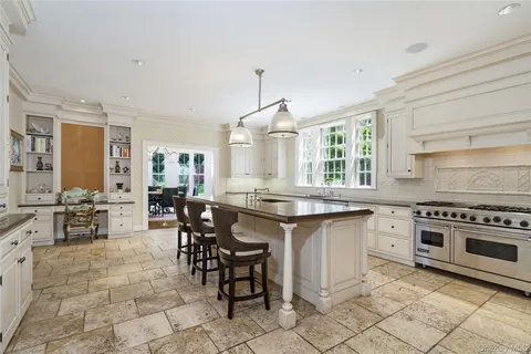 a kitchen with cabinets table and chairs