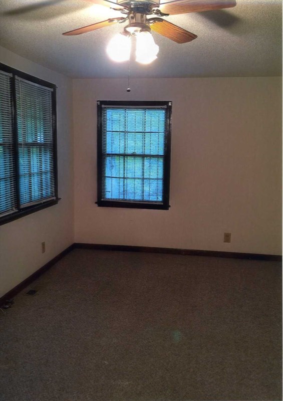 6829 Lower Thomaston Road Macon, GA 31220 - Photo 3 of 11 an empty room with a fireplace