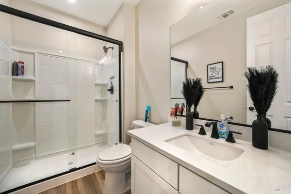 a bedroom with a bed a window and dresser