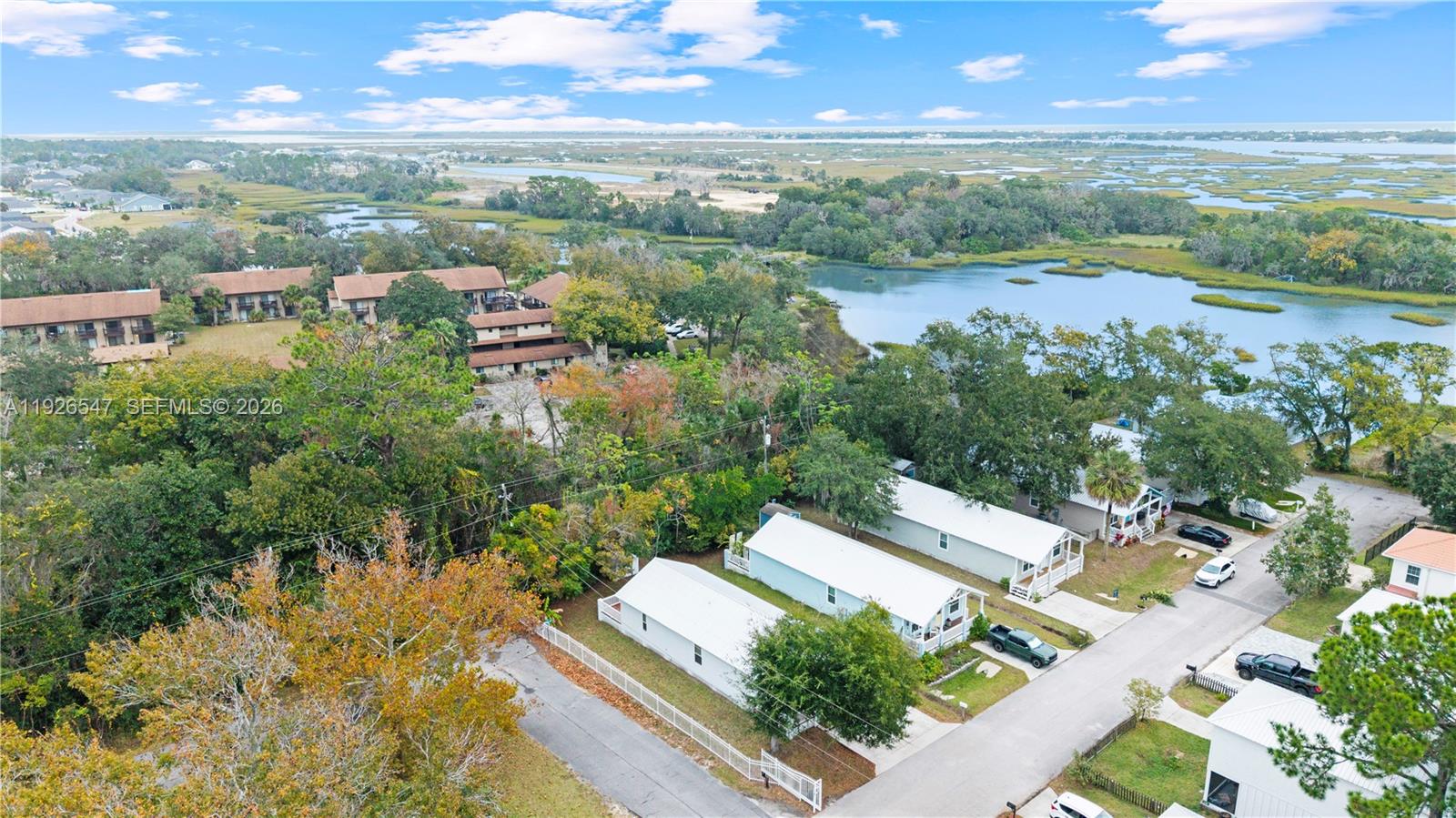 2 Poinciana Cove Road St. Augustine, FL 32084 - Photo 36 of 43 a view of a lake with lawn chairs