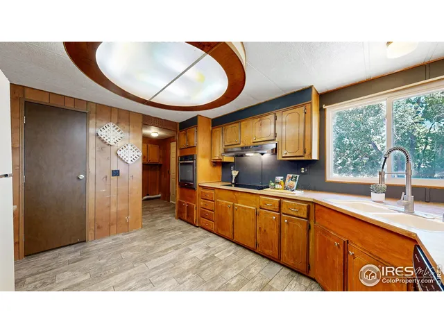 a kitchen with stainless steel appliances granite countertop a sink a stove and a refrigerator