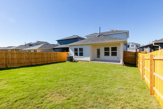 a view of a house with a backyard