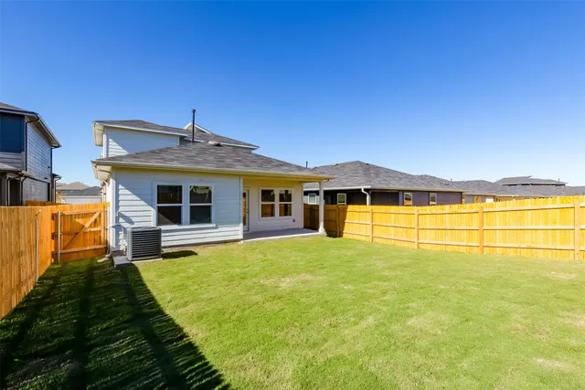 a front view of a house with swimming pool having outdoor seating