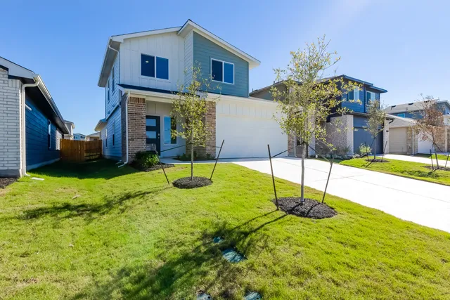 a house that has a tree in front of it