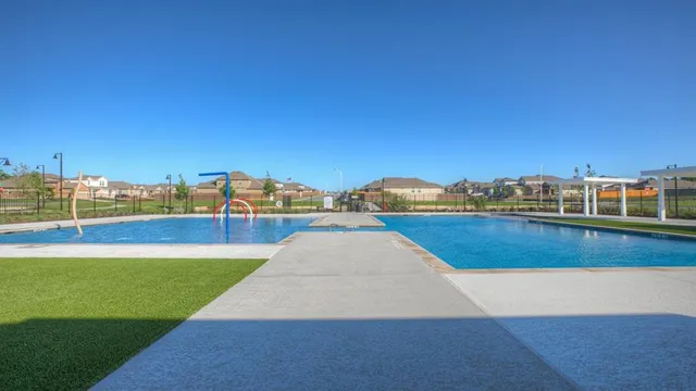 a view of swimming pool with a lawn chairs