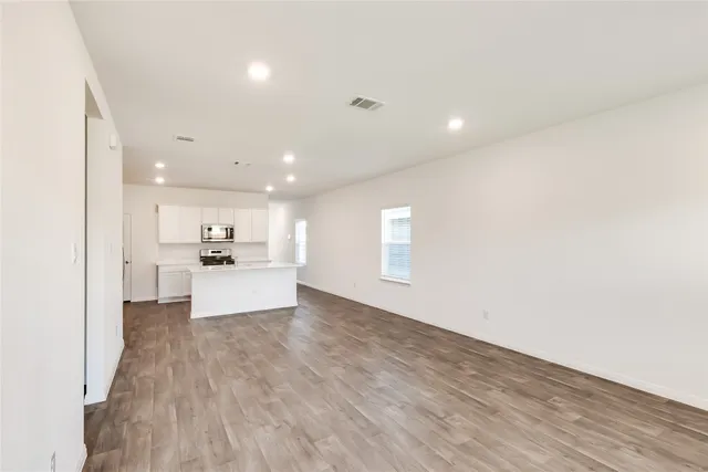 a view of kitchen with kitchen island and stainless steel appliances