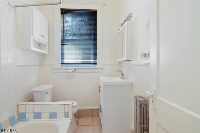 a bathroom with a sink toilet and mirror