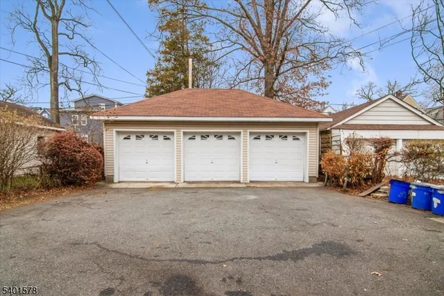 a view of a house with a yard and garage