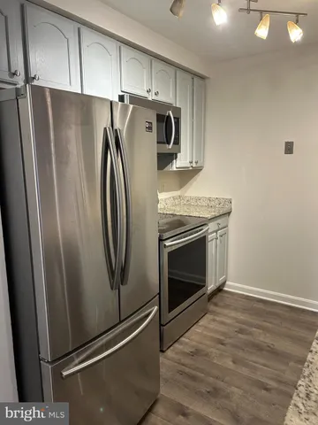 a metallic refrigerator freezer sitting in a kitchen