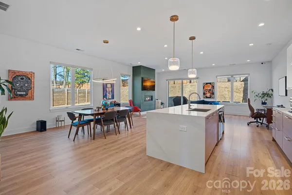 a living room filled with furniture and a wooden floor