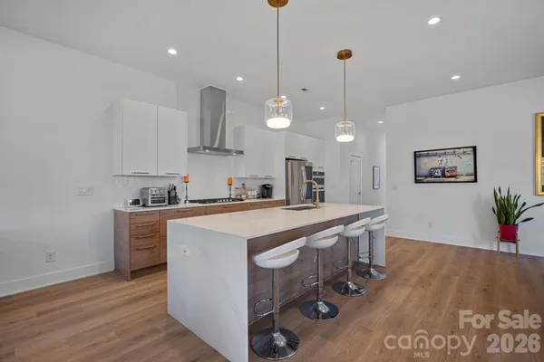 a kitchen with kitchen island a sink stainless steel appliances and cabinets