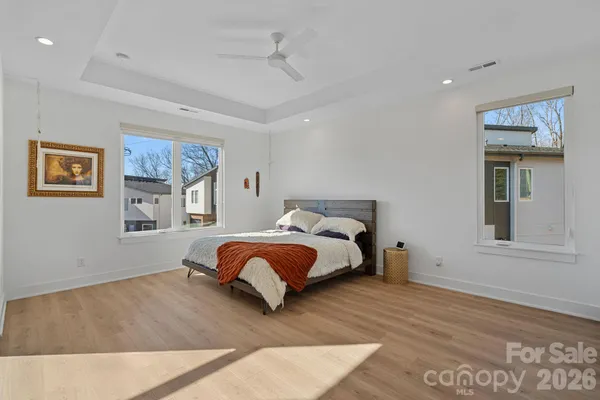 a bedroom with a bed and painting on the wall