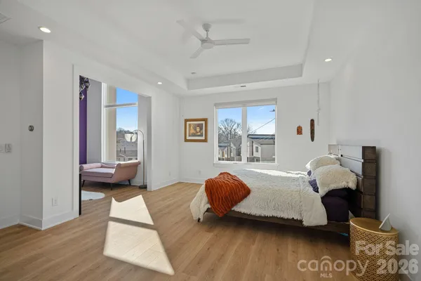 a bedroom with a bed and wooden floor