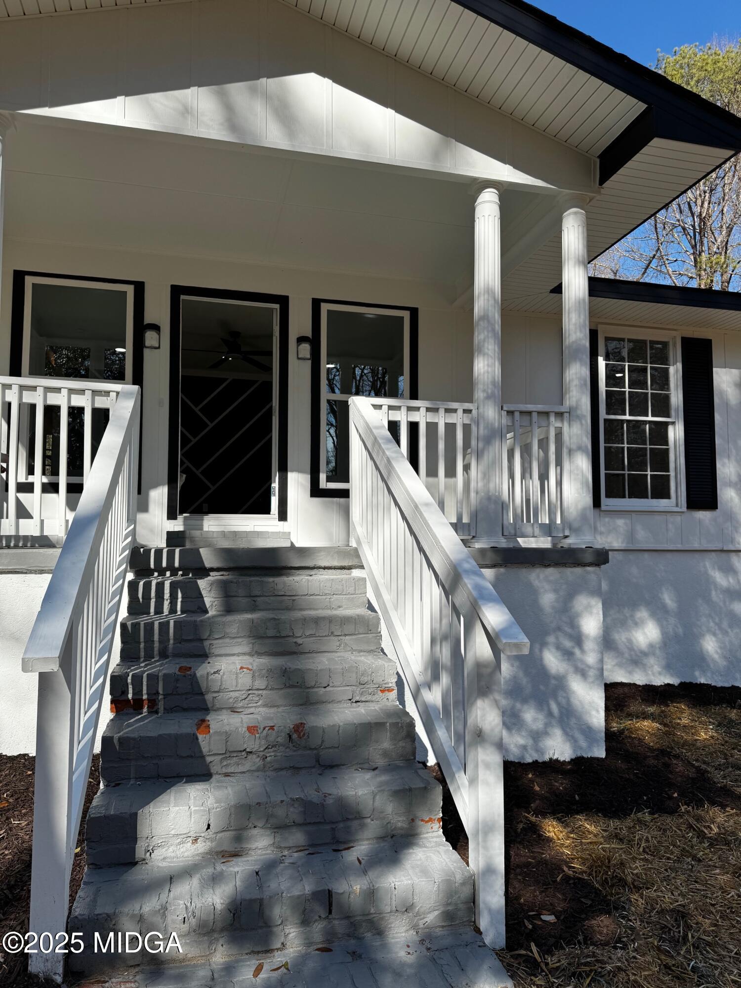 4105 Holley Road Lizella, GA 31052 - Photo 11 of 78 a view of staircase with lots of frames on wall and windows