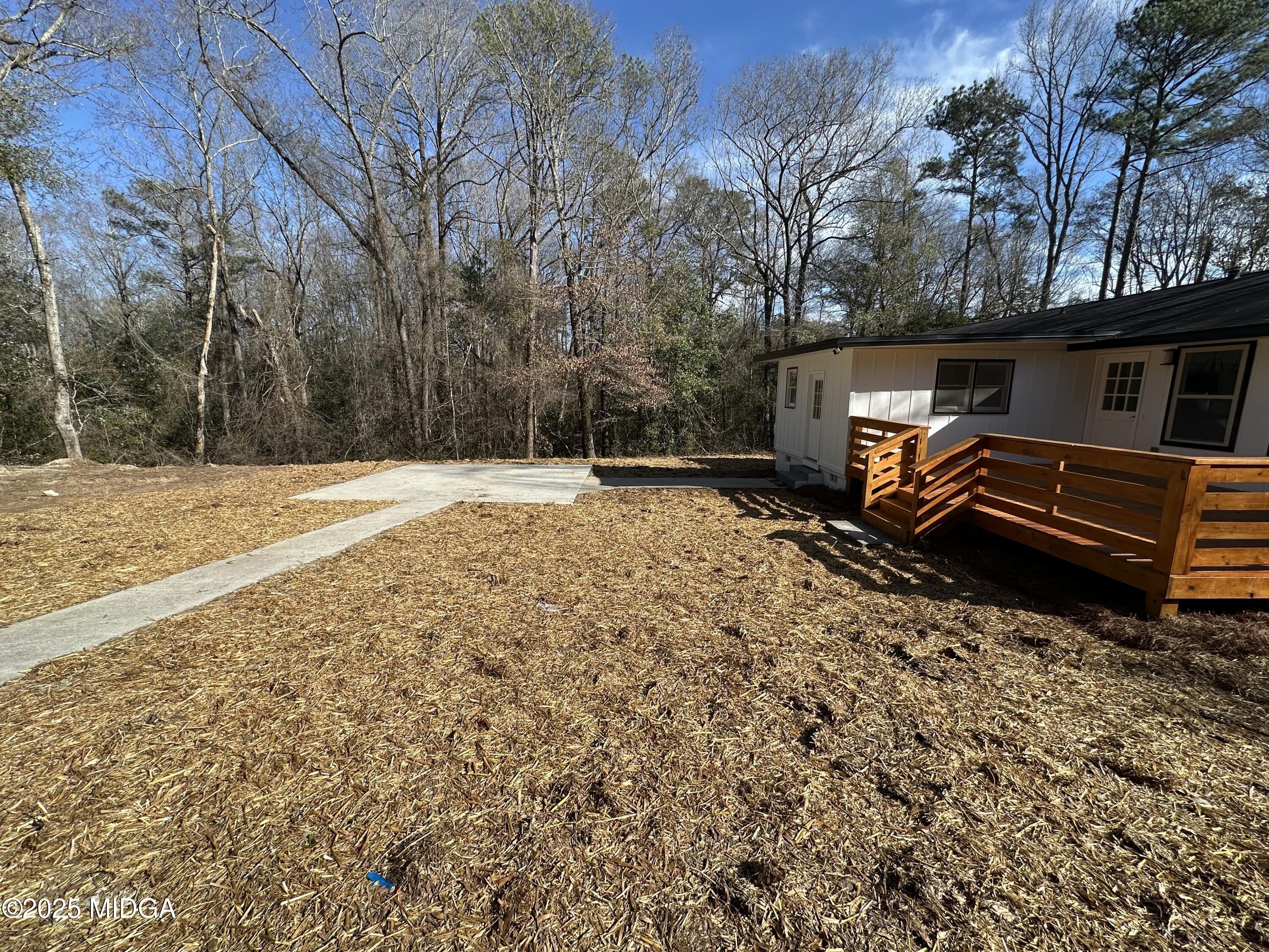 4105 Holley Road Lizella, GA 31052 - Photo 14 of 78 a backyard of a house with barbeque oven table and chairs