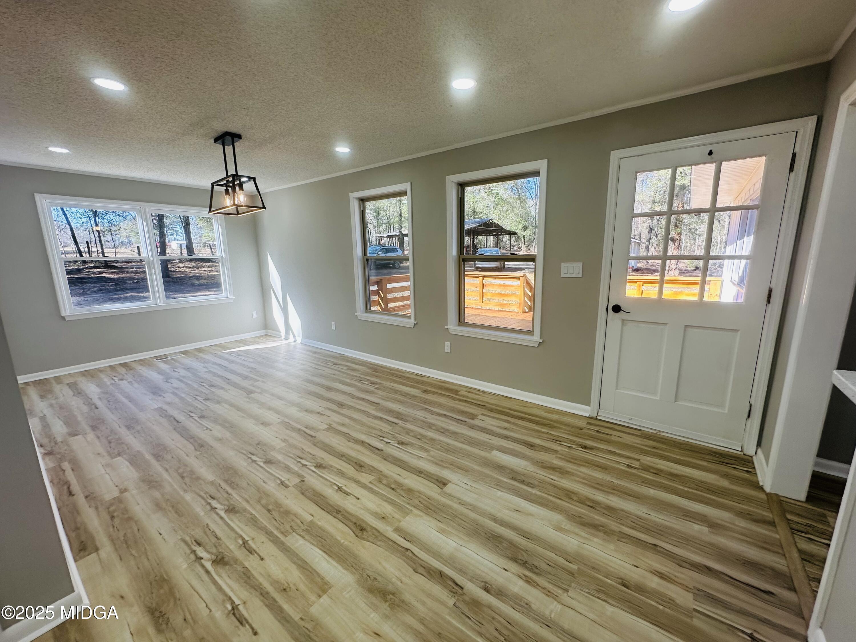 4105 Holley Road Lizella, GA 31052 - Photo 26 of 78 a view of an empty room with a window and wooden floor