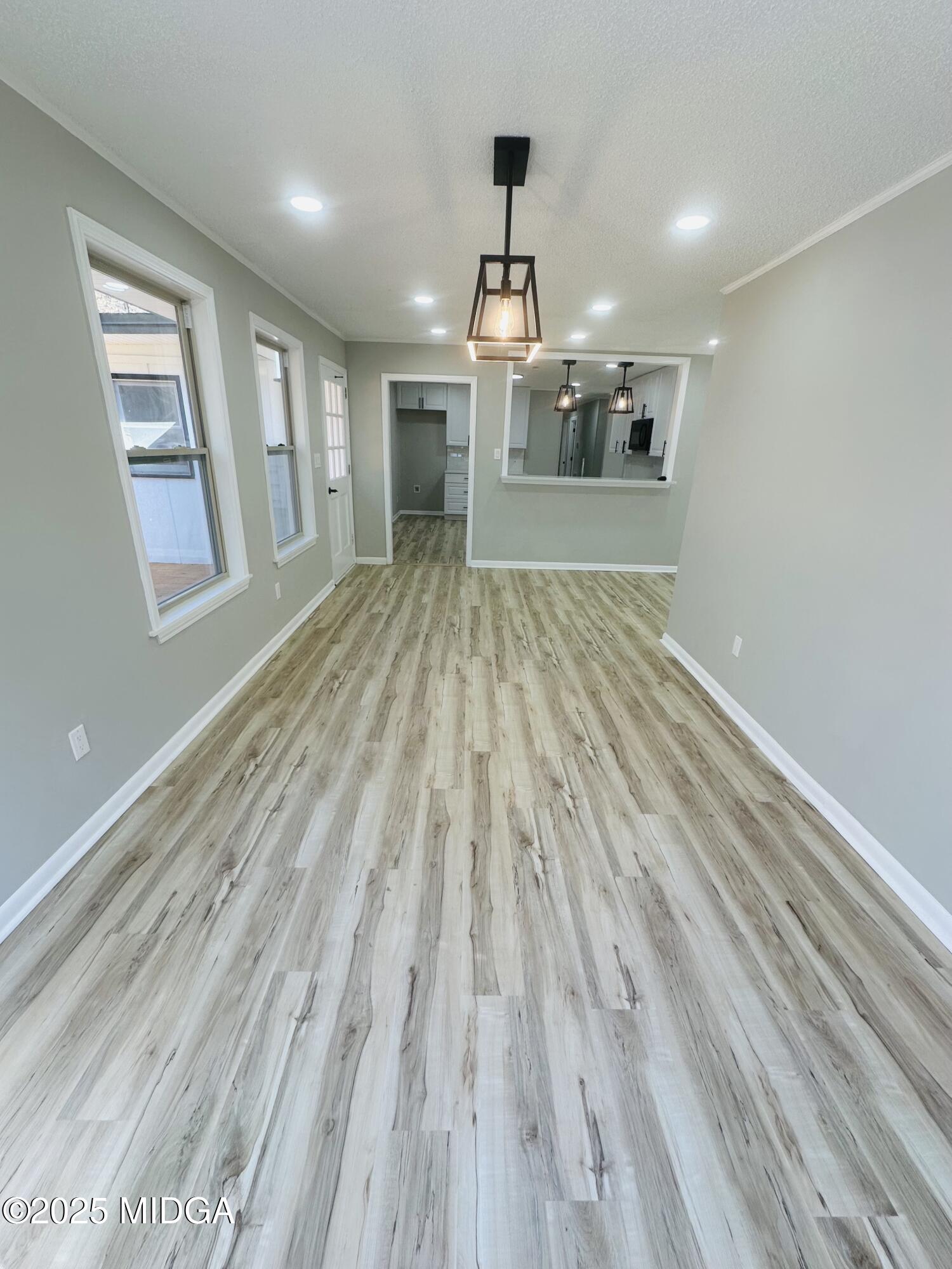 4105 Holley Road Lizella, GA 31052 - Photo 27 of 78 wooden floor in an empty room with a kitchen