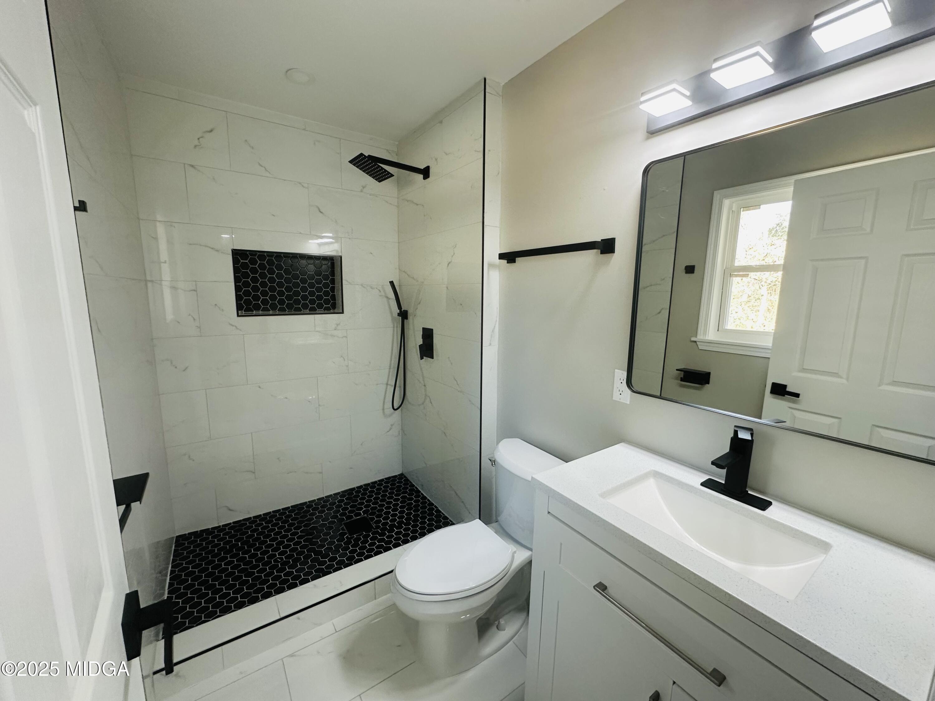 4105 Holley Road Lizella, GA 31052 - Photo 39 of 78 a bathroom with a sink toilet and shower