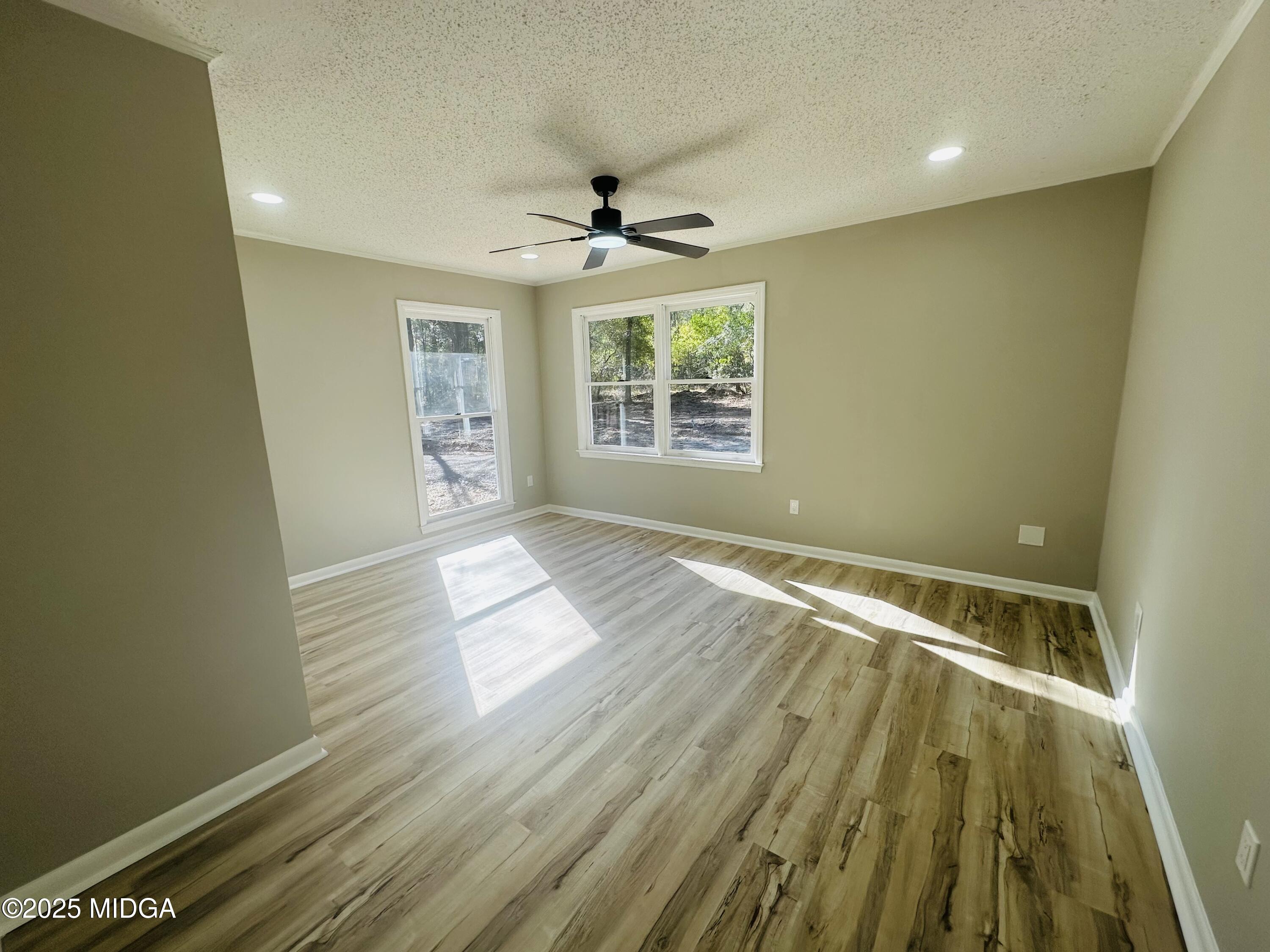 4105 Holley Road Lizella, GA 31052 - Photo 42 of 78 a view of an empty room with wooden floor and a window