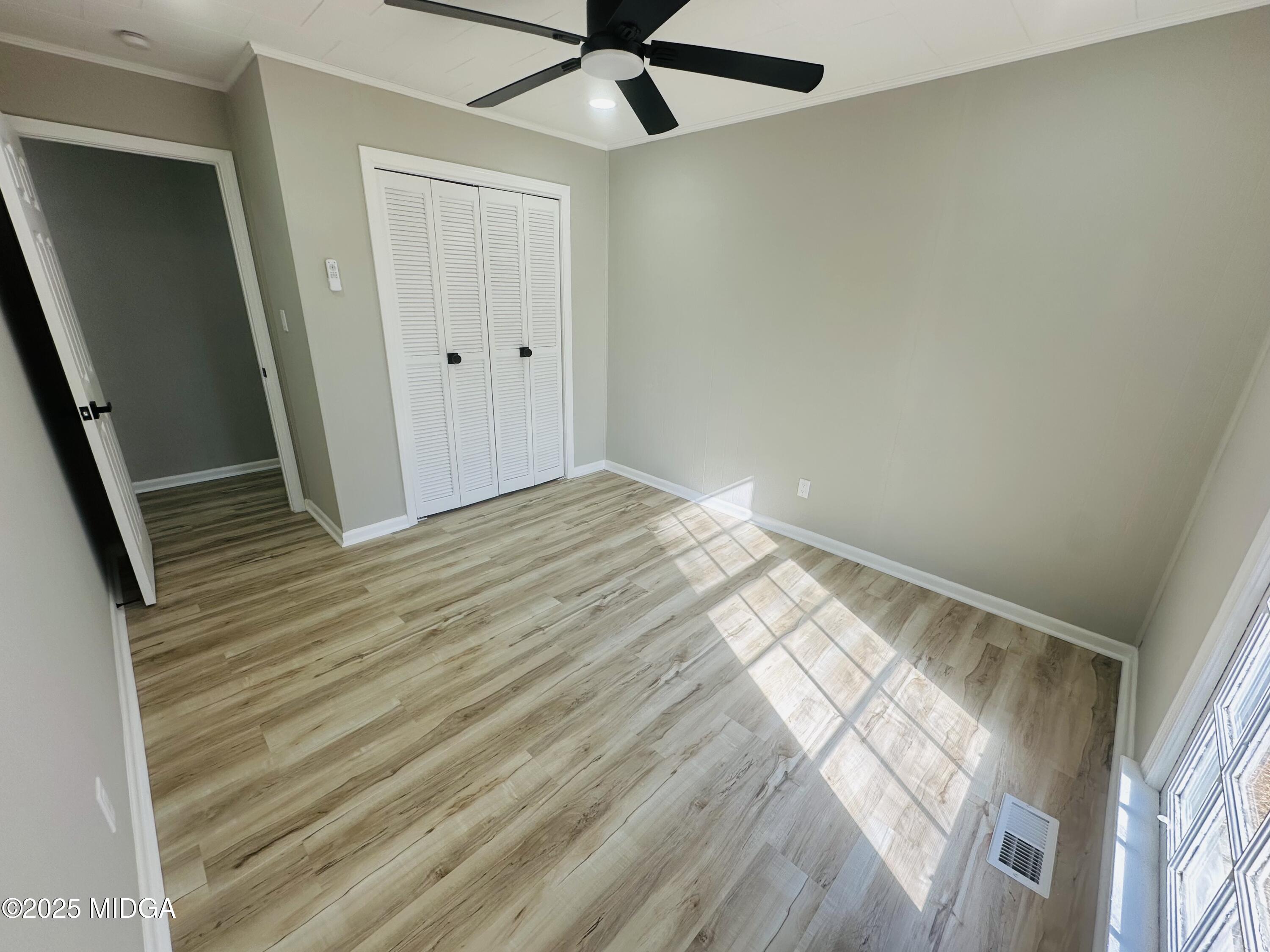 4105 Holley Road Lizella, GA 31052 - Photo 46 of 78 a view of empty room with wooden floor and fan