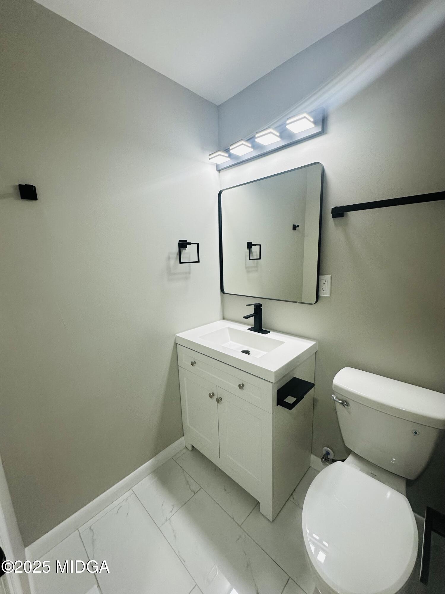 4105 Holley Road Lizella, GA 31052 - Photo 50 of 78 a bathroom with a toilet sink and mirror