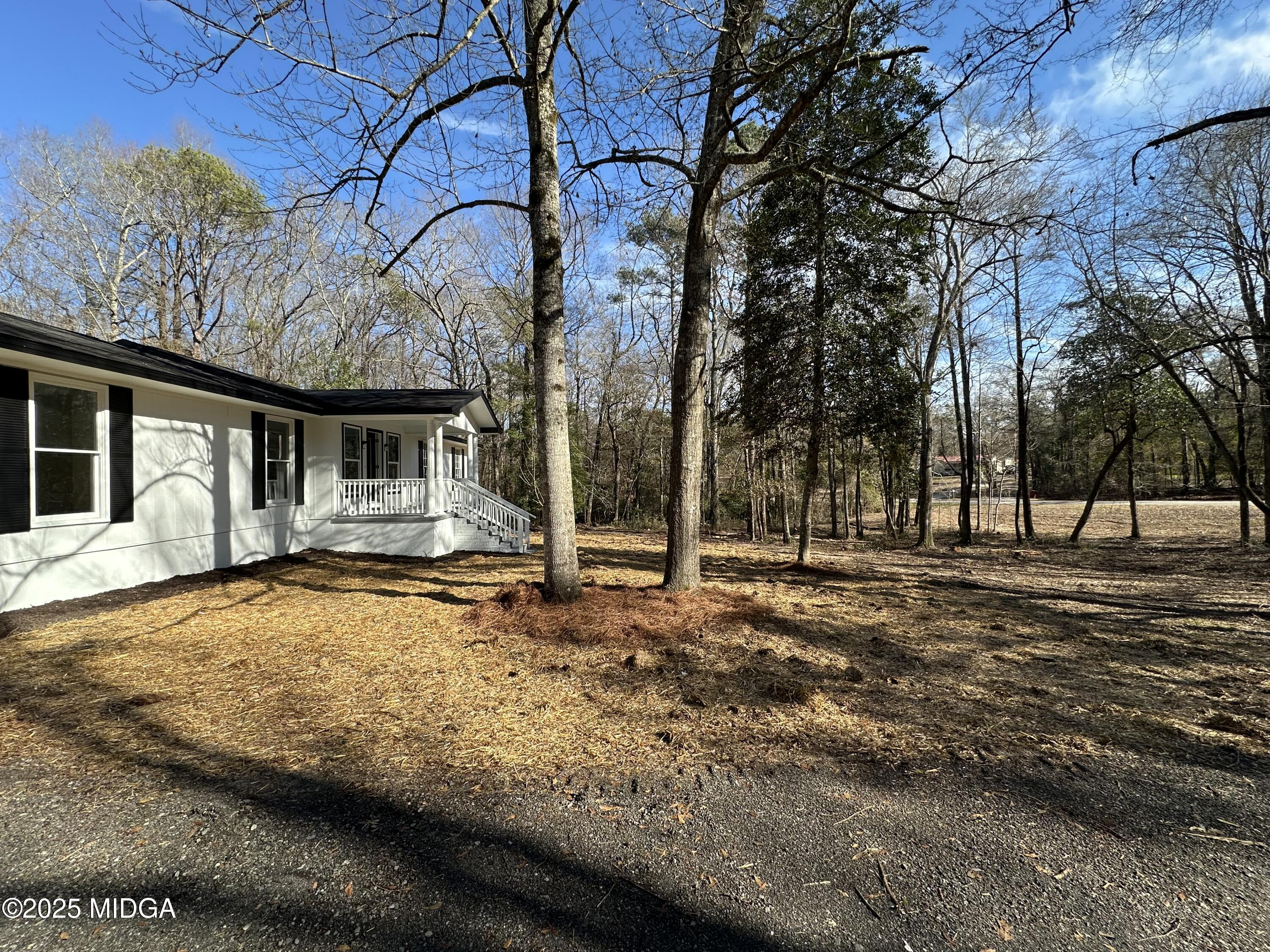 4105 Holley Road Lizella, GA 31052 - Photo 5 of 78 a backyard of a house with large trees