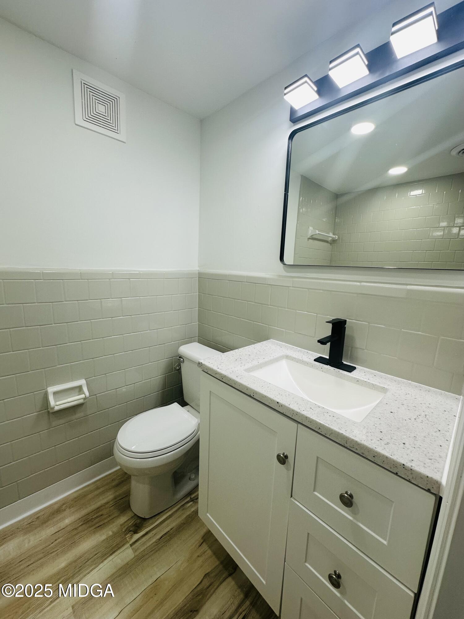 4105 Holley Road Lizella, GA 31052 - Photo 56 of 78 a bathroom with a granite countertop toilet sink and mirror