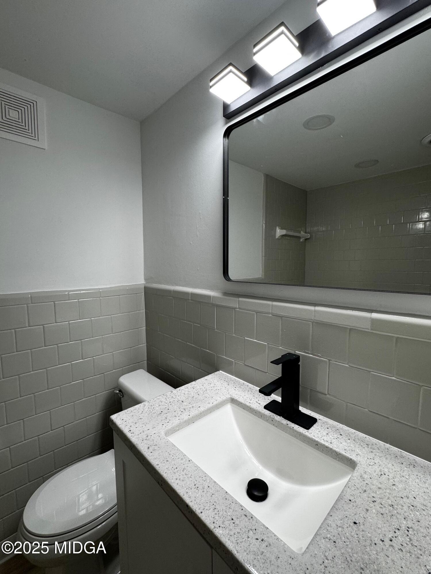 4105 Holley Road Lizella, GA 31052 - Photo 60 of 78 a bathroom with a sink a toilet and mirror