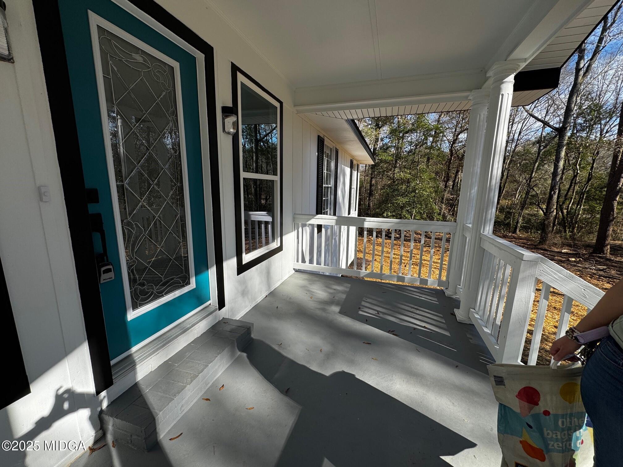 4105 Holley Road Lizella, GA 31052 - Photo 7 of 78 a view of a porch with wooden floor and furniture