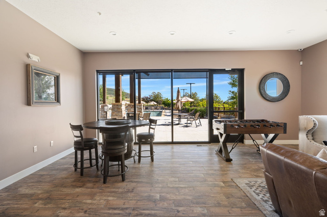 910 Wasatch Drive Kamas, UT 84036 - Photo 26 of 36 Entertainment space featuring wood-finish flooring, recessed lighting, and expansive glass sliding doors opening to an exterior patio